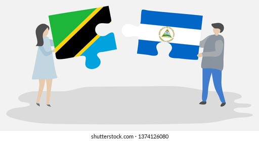 Couple holding two puzzles pieces with Tanzanian and Nicaraguan flags. Tanzania and Nicaragua national symbols together.