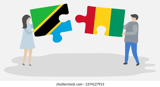Couple holding two puzzles pieces with Tanzanian and Guinean flags. Tanzania and Guinea national symbols together.