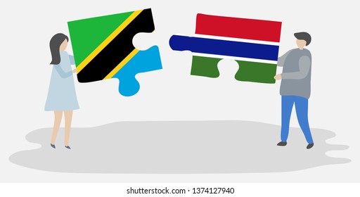 Couple holding two puzzles pieces with Tanzanian and Gambian flags. Tanzania and Gambia national symbols together.