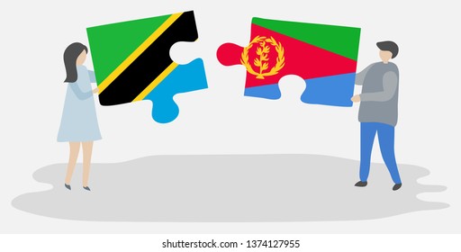 Couple holding two puzzles pieces with Tanzanian and Eritrean flags. Tanzania and Eritrea national symbols together.
