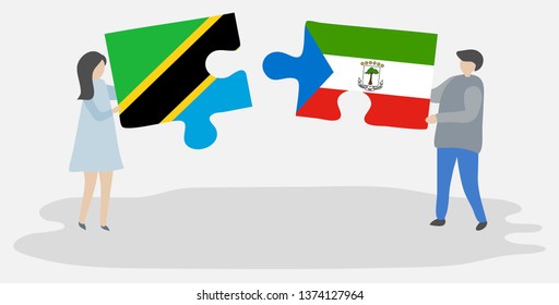 Couple holding two puzzles pieces with Tanzanian and Equatorial Guinean flags. Tanzania and Equatorial Guinea national symbols together.