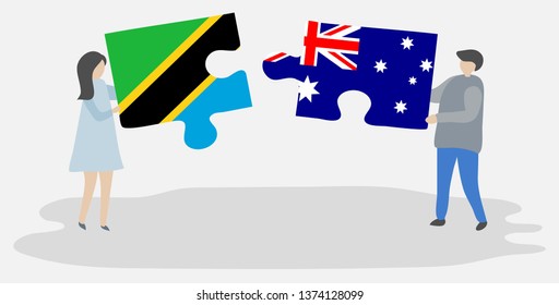 Couple holding two puzzles pieces with Tanzanian and Australian flags. Tanzania and Australia national symbols together.