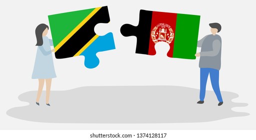 Couple holding two puzzles pieces with Tanzanian and Afghan flags. Tanzania and Afghanistan national symbols together.
