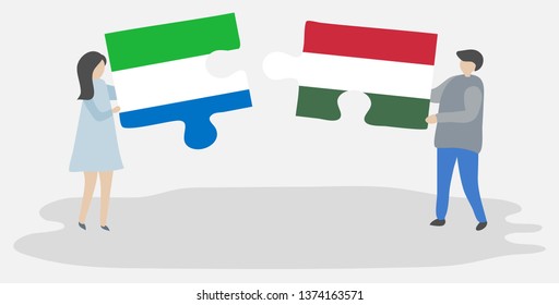 Couple holding two puzzles pieces with Sierra Leonean and Hungarian flags. Sierra Leone and Hungary national symbols together.
