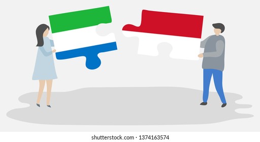 Couple holding two puzzles pieces with Sierra Leonean and Indonesian flags. Sierra Leone and Indonesia national symbols together.
