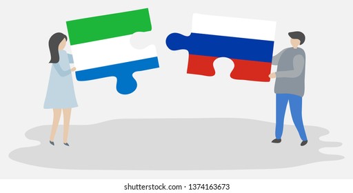 Couple holding two puzzles pieces with Sierra Leonean and Russian flags. Sierra Leone and Russia national symbols together.