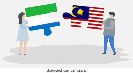 Couple holding two puzzles pieces with Sierra Leonean and Malaysian flags. Sierra Leone and Malaysia national symbols together.