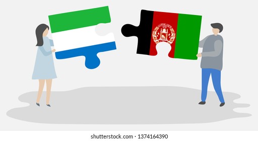 Couple holding two puzzles pieces with Sierra Leonean and Afghan flags. Sierra Leone and Afghanistan national symbols together.