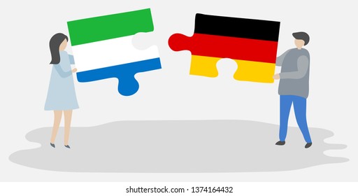 Couple holding two puzzles pieces with Sierra Leonean and German flags. Sierra Leone and Germany national symbols together.