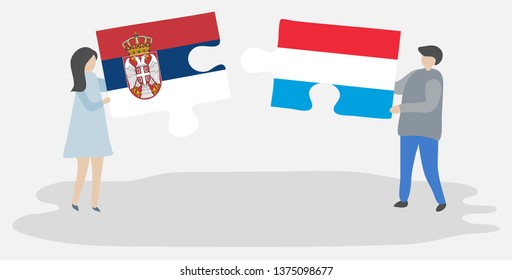 Couple holding two puzzles pieces with Serbian and Luxembourgish flags. Serbia and Luxembourg national symbols together.