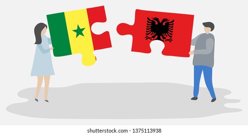 Couple holding two puzzles pieces with Senegalese and Albanian flags. Senegal and Albania national symbols together.