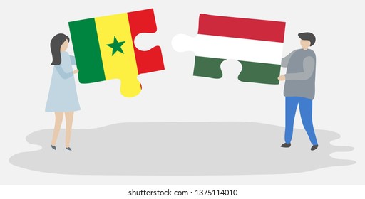 Couple holding two puzzles pieces with Senegalese and Hungarian flags. Senegal and Hungary national symbols together.