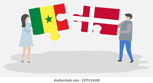 Couple holding two puzzles pieces with Senegalese and Danish flags. Senegal and Denmark national symbols together.