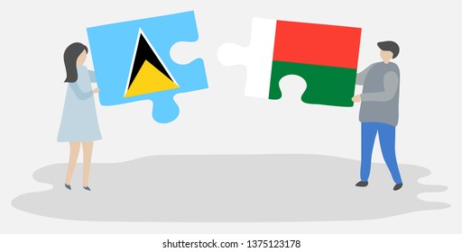 Couple holding two puzzles pieces with Saint Lucian and Malagasy flags. Saint Lucia and Madagascar national symbols together.