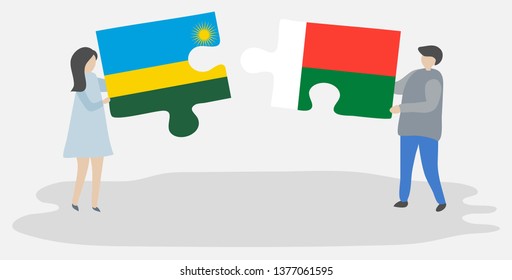 Couple holding two puzzles pieces with Rwandan and Malagasy flags. Rwanda and Madagascar national symbols together.