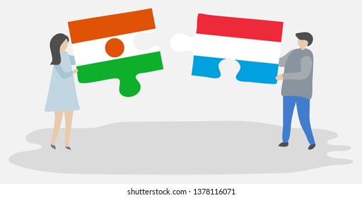 Couple holding two puzzles pieces with Nigerien and Luxembourgish flags. Niger and Luxembourg national symbols together.