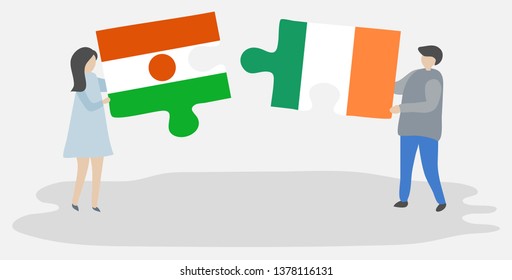Couple holding two puzzles pieces with Nigerien and Irish flags. Niger and Ireland national symbols together.