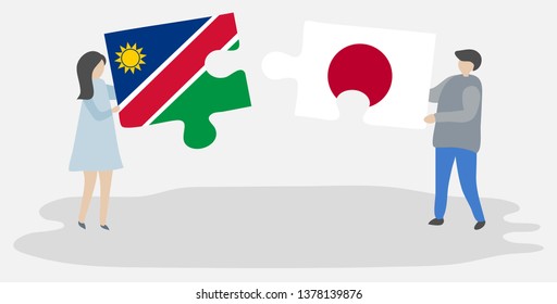 Couple holding two puzzles pieces with Namibian and Japanese flags. Namibia and Japan national symbols together.