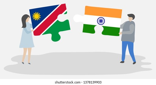 Couple holding two puzzles pieces with Namibian and Indian flags. Namibia and India national symbols together.