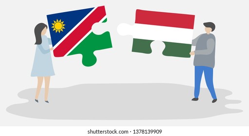 Couple holding two puzzles pieces with Namibian and Hungarian flags. Namibia and Hungary national symbols together.