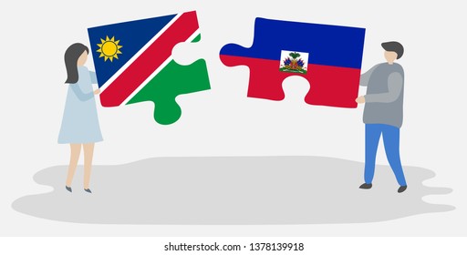 Couple holding two puzzles pieces with Namibian and Haitian flags. Namibia and Haiti national symbols together.