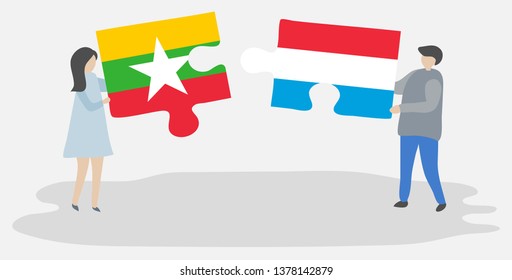 Couple holding two puzzles pieces with Burmese and Luxembourgish flags. Myanmar and Luxembourg national symbols together.