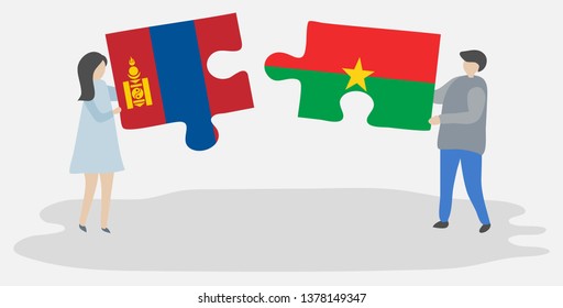 Couple holding two puzzles pieces with Mongolian and Burkinabe flags. Mongolia and Burkina Faso national symbols together.