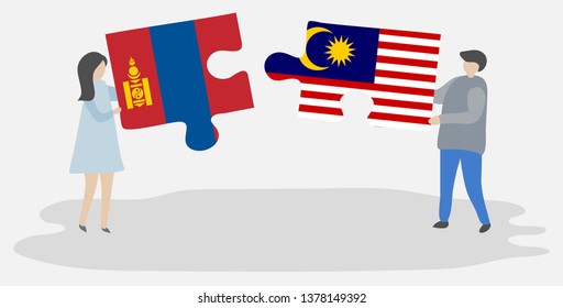 Couple holding two puzzles pieces with Mongolian and Malaysian flags. Mongolia and Malaysia national symbols together.