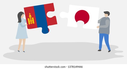 Couple holding two puzzles pieces with Mongolian and Japanese flags. Mongolia and Japan national symbols together.