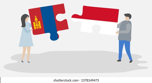 Couple holding two puzzles pieces with Mongolian and Indonesian flags. Mongolia and Indonesia national symbols together.
