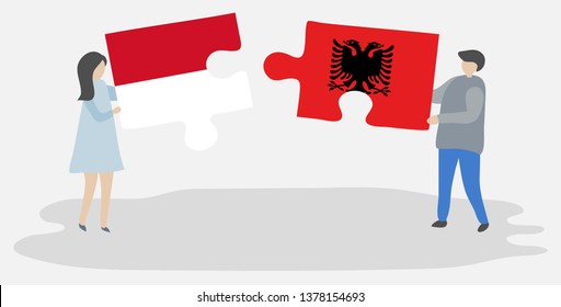 Couple holding two puzzles pieces with Monegasque and Albanian flags. Monaco and Albania national symbols together.