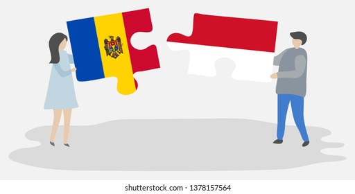 Couple holding two puzzles pieces with Moldovan and Indonesian flags. Moldova and Indonesia national symbols together.