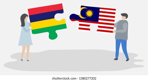 Couple holding two puzzles pieces with Mauritian and Malaysian flags. Mauritius and Malaysia national symbols together.