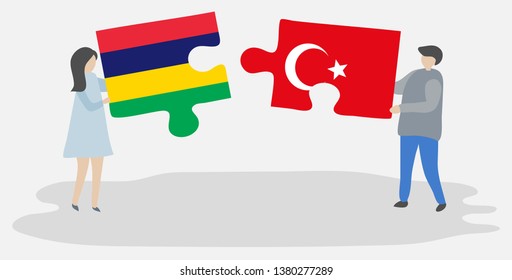Couple holding two puzzles pieces with Mauritian and Turkish flags. Mauritius and Turkey national symbols together.