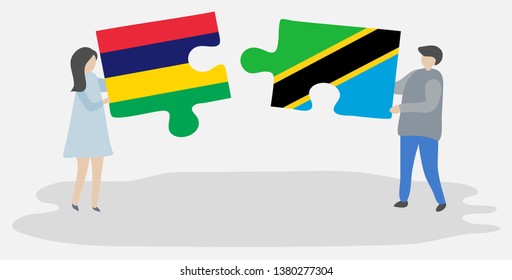 Couple holding two puzzles pieces with Mauritian and Tanzanian flags. Mauritius and Tanzania national symbols together.