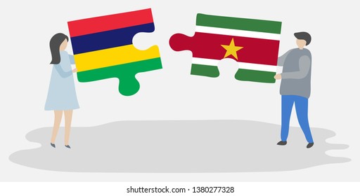 Couple holding two puzzles pieces with Mauritian and Surinamese flags. Mauritius and Suriname national symbols together.