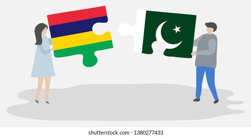 Couple holding two puzzles pieces with Mauritian and Pakistani flags. Mauritius and Pakistan national symbols together.