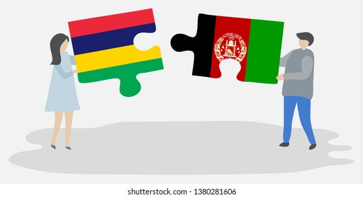 Couple holding two puzzles pieces with Mauritian and Afghan flags. Mauritius and Afghanistan national symbols together.