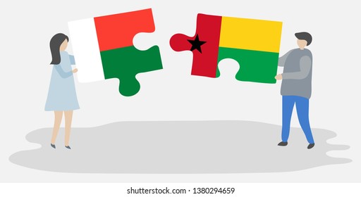Couple holding two puzzles pieces with Malagasy and Bissau-Guinean flags. Madagascar and Guinea-Bissau national symbols together.