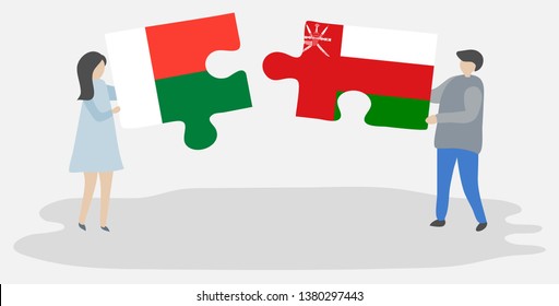 Couple holding two puzzles pieces with Malagasy and Omani flags. Madagascar and Oman national symbols together.