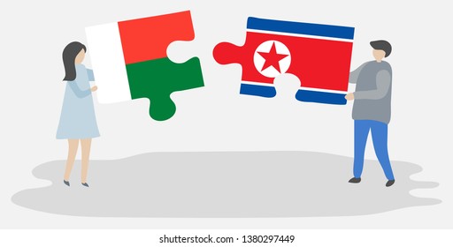 Couple holding two puzzles pieces with Malagasy and North Korean flags. Madagascar and North Korea national symbols together.