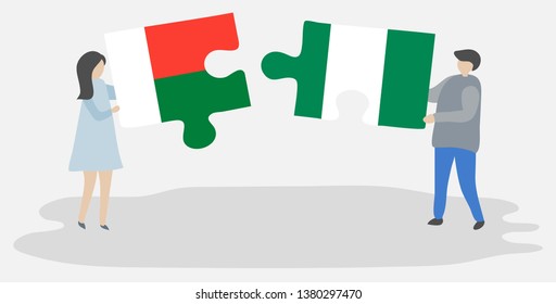 Couple holding two puzzles pieces with Malagasy and Nigerian flags. Madagascar and Nigeria national symbols together.
