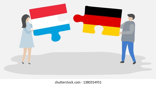 Couple holding two puzzles pieces with Luxembourgish and German flags. Luxembourg and Germany national symbols together.