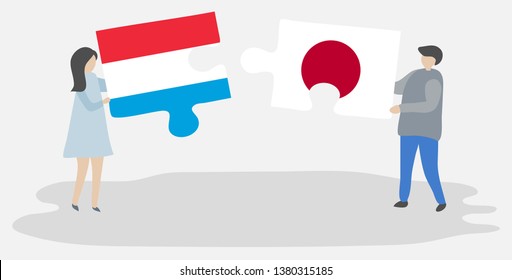 Couple holding two puzzles pieces with Luxembourgish and Japanese flags. Luxembourg and Japan national symbols together.