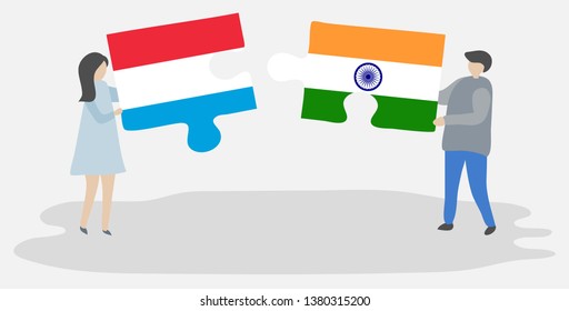 Couple holding two puzzles pieces with Luxembourgish and Indian flags. Luxembourg and India national symbols together.