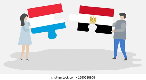Couple holding two puzzles pieces with Luxembourgish and Egyptian flags. Luxembourg and Egypt national symbols together.