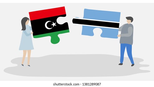 Couple holding two puzzles pieces with Libyan and Motswana flags. Libya and Botswana national symbols together.