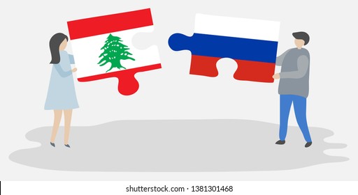Couple holding two puzzles pieces with Lebanese and Russian flags. Lebanon and Russia national symbols together.