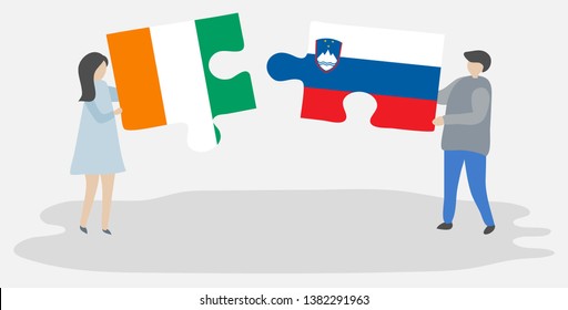 Couple holding two puzzles pieces with Ivorian and Slovenian flags. Ivory Coast and Slovenia national symbols together.