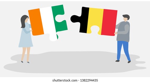 Couple holding two puzzles pieces with Ivorian and Belgian flags. Ivory Coast and Belgium national symbols together.